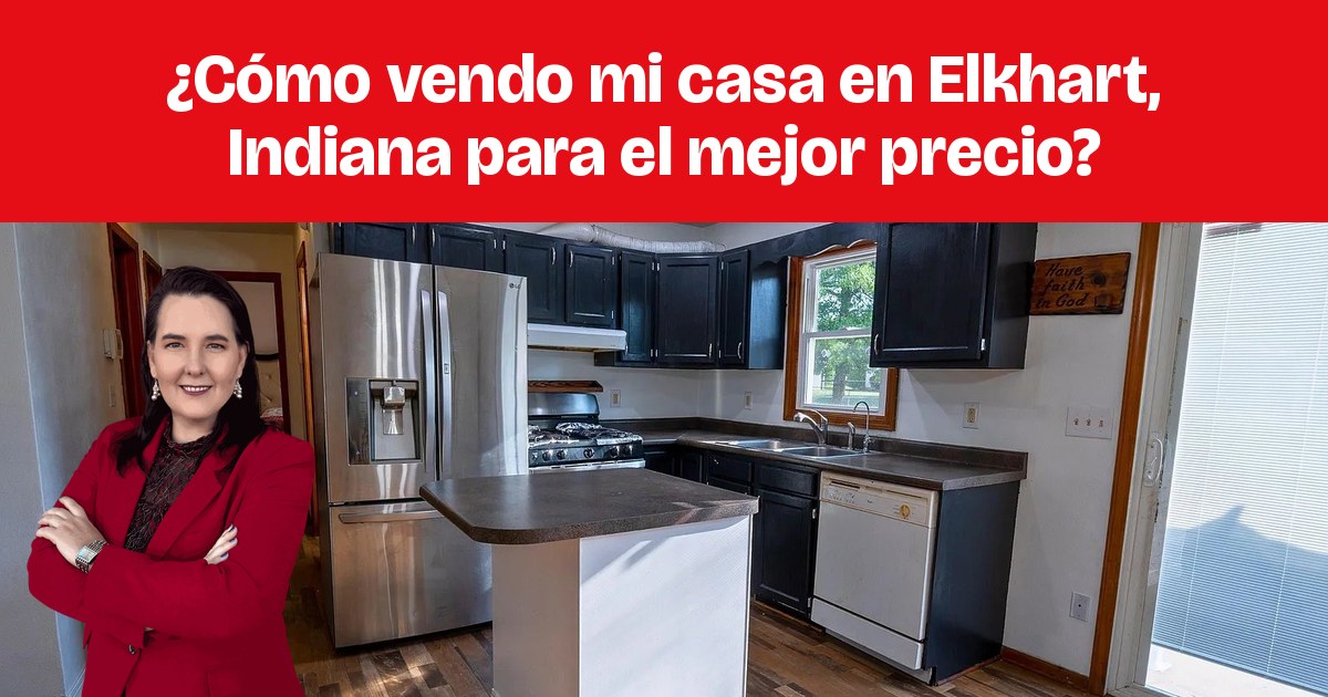 Una cocina con gabinetes oscuros, isla central y electrodomésticos de acero inoxidable.
