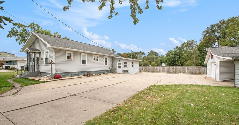 A single-story ranch home with a long driveway.