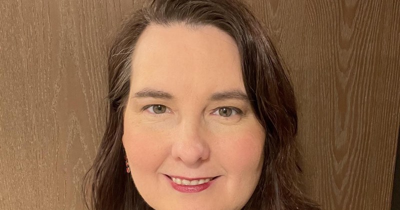 Warm portrait of Lisa Collio in a red top.