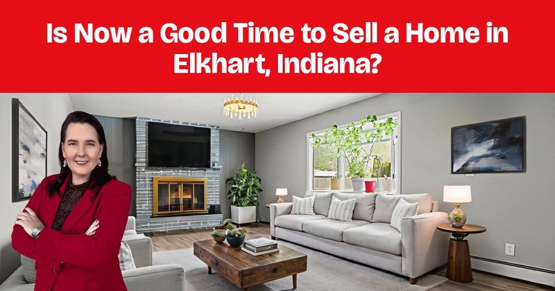 A staged living room with gray sofas, a brick fireplace, and a patterned rug.