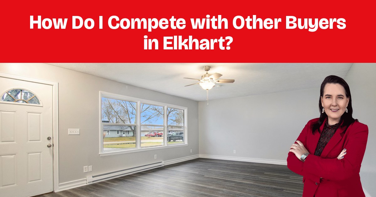 An empty living room with a front door, an arched window, and warm wood floors.