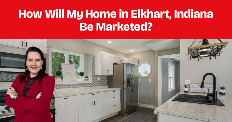 A kitchen with white cabinets, a gas range, wood floors, and a hanging pot rack.