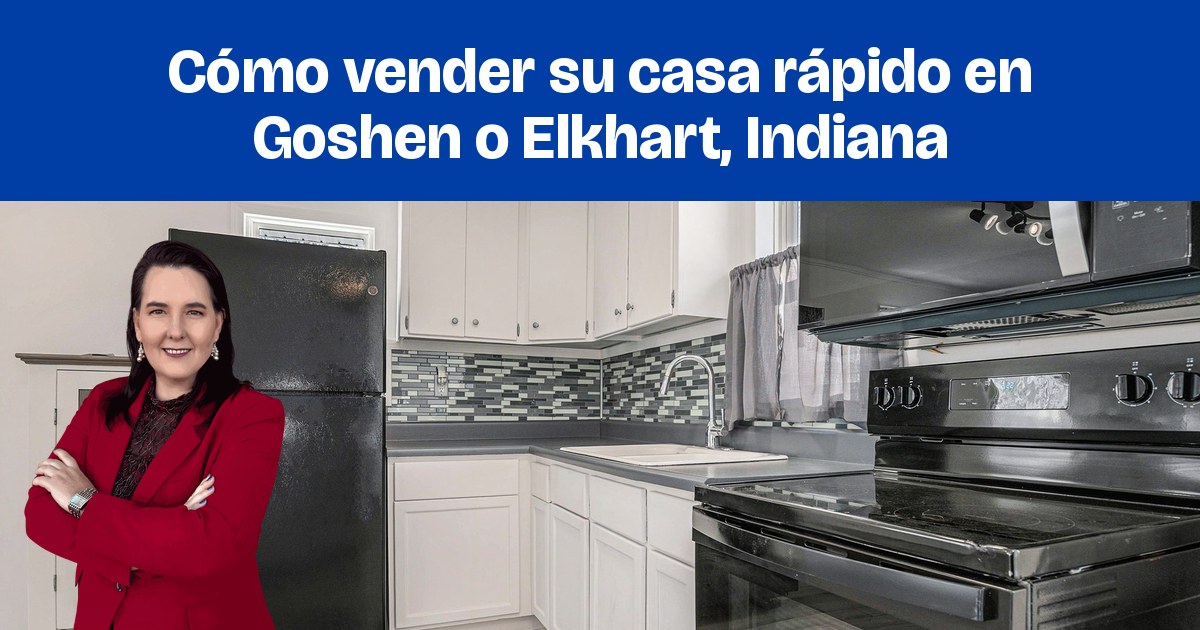 Una cocina renovada con gabinetes blancos, electrodomésticos negros y un mosaico de azulejos gris azulado.