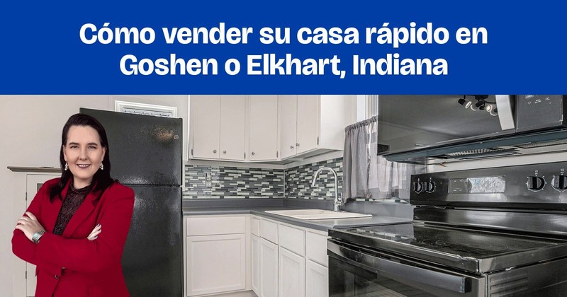 Una cocina renovada con gabinetes blancos, electrodomésticos negros y un mosaico de azulejos gris azulado.