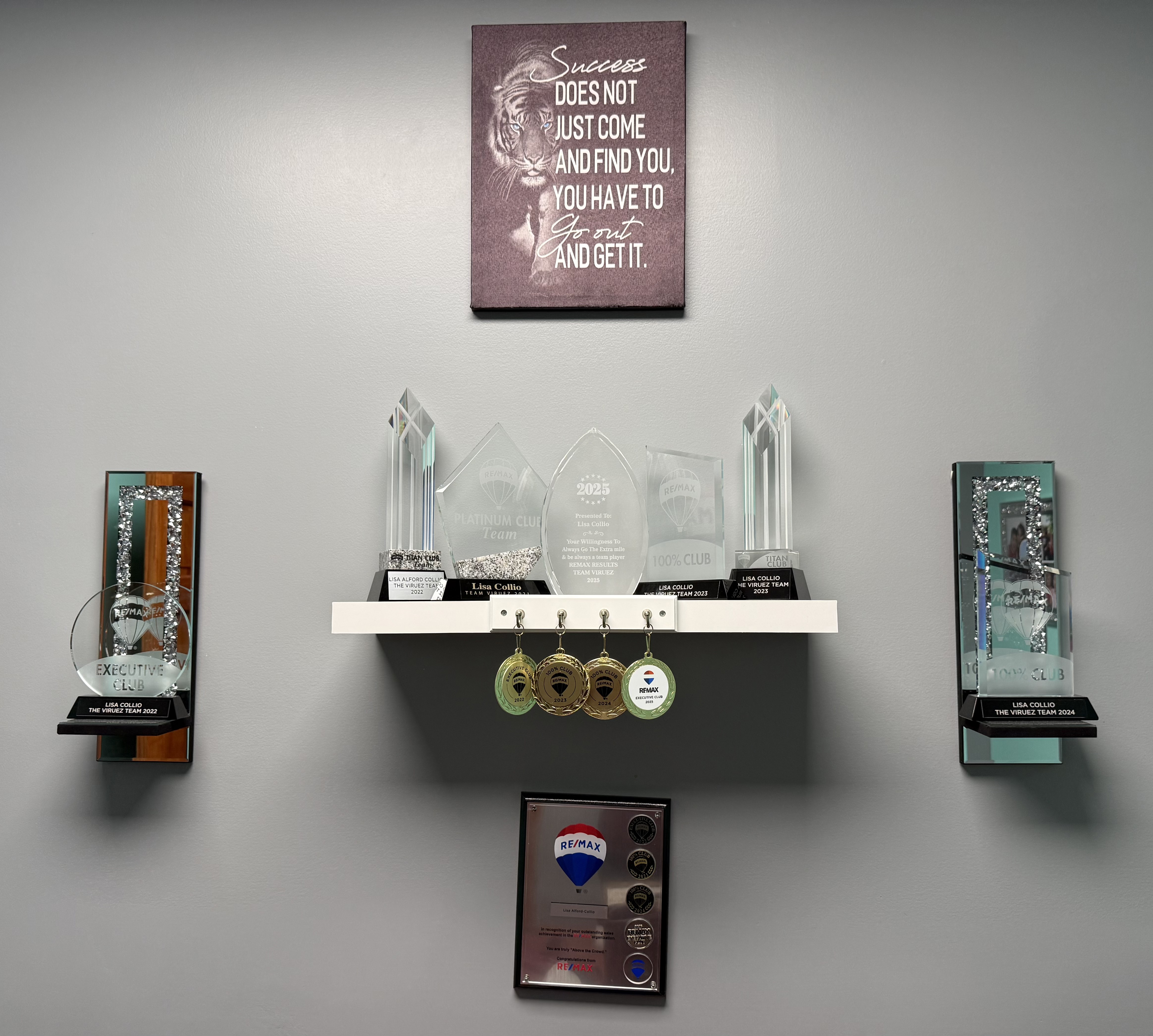 RE/MAX awards and trophies earned by Lisa Collio, displayed in her Goshen office.