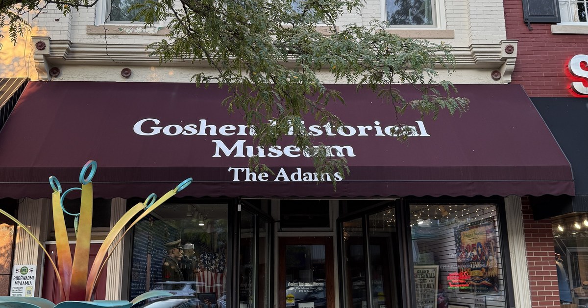 A historic museum building with an awning on a downtown street in Goshen, Indiana.