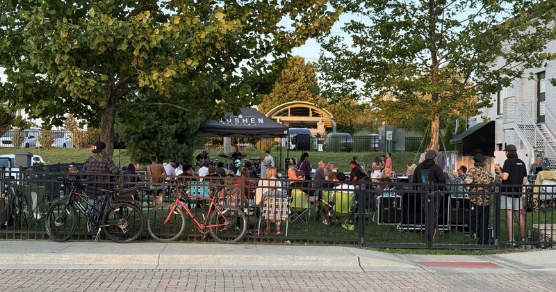 A crowd gathered along a downtown street for a community event.