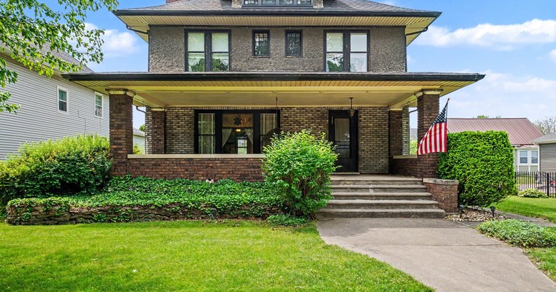 A two-storey home with a deep covered front porch.