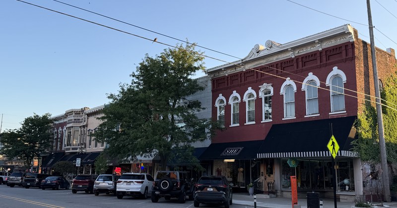 A row of downtown Goshen storefronts on a sunny afternoon.