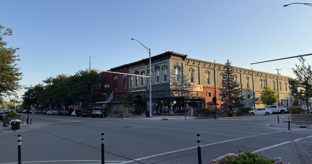 A downtown intersection with two-storey brick commercial buildings.